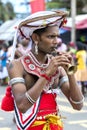 A Trumpet Blower performs along the road during the Hikkaduwa Perahara in Sri Lanka.