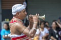 A Trumpet Blower performs during the Day Perahera.