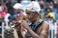 A Trumpet Blower performs along the streets of Kandy during the daytime Perahera in Kandy, Sri Lanka.