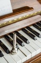 trumpet mouthpiece upon the piano keys, close up Royalty Free Stock Photo