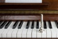 Trumpet mouthpiece upon the piano keys, close up Royalty Free Stock Photo