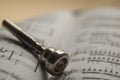 Trumpet mouthpiece on sheet music book Royalty Free Stock Photo