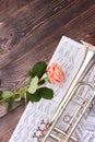 Trumpet, musical notes and pink rose.