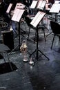 trumpet and mute stand on stage during an intermission in a theater