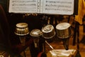 Trumpet mutes in a row with sheet music on a stand. Royalty Free Stock Photo