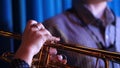 Trumpet player. Trumpeter hands playing brass music instrument close up