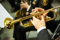 The trumpeter is playing on a silver trumpet. Trumpet players