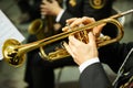 The trumpeter is playing on a silver trumpet. Trumpet players