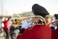 Trumpeter plays in orchestra. Musician with wind musical instrument. Red clothes