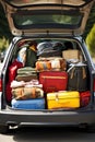 The trunk of a car full of suitcases and things. Travel by car.