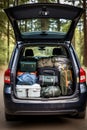 The trunk of a car full of suitcases and things. Travel by car.