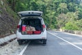 Trunk of the car packed with supplies for weekend road trip. Picnic concept. SUV parked side the road Royalty Free Stock Photo