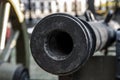 Trunk of a heavy cast-iron gun close up, smooth-bore cannon