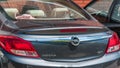 Trunk and red stop lights with logo on new Opel Insignia car close up.