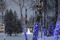 Trunks of trees in Christmas bulbs and garlands, Royalty Free Stock Photo