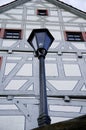 Street lamp in retro style in front of a well-kept half-timbered facade 2 Royalty Free Stock Photo