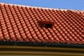 Truss with Italian folded tiles and metal gutter. you can see the ridge of the roof with concrete tiles, sunny, blue sky. the vent