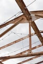 Trusses overhead and open to the sky with rust and strings of lights