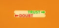 Trust or doubt symbol. Concept word Trust or Doubt on beautiful wooden stick. Beautiful orange table orange background. Business
