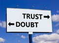 Trust or doubt symbol. Concept word Trust or Doubt on beautiful billboard with two arrows. Beautiful blue sky with clouds