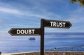 Trust or doubt symbol. Concept word Trust or Doubt on beautiful signpost with two arrows. Beautiful blue sea sky with clouds