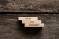 Trust and integrity sign written on three stacked wooden pegs