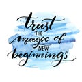 Trust the magic of new beginnings. Inspiration saying. Vector brush calligraphy on blue watercolor strokes. Encouraging Royalty Free Stock Photo
