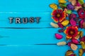 Trust word on blue wood with flower