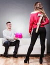 Trusting guy giving present to misleading girl