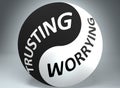 Trusting and worrying in balance - pictured as words Trusting, worrying and yin yang symbol, to show harmony between Trusting and