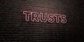 TRUSTS -Realistic Neon Sign on Brick Wall background - 3D rendered royalty free stock image