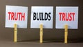 Truth builds trust symbol. Concept words Truth builds trust on white paper on clothespin on a beautiful grey table grey background