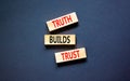 Truth builds trust symbol. Concept words Truth builds trust on wooden blocks on a beautiful black table black background. Business