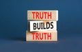 Truth builds trust symbol. Concept words Truth builds trust on wooden blocks on a beautiful grey table grey background. Business