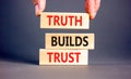 Truth builds trust symbol. Concept words Truth builds trust on wooden blocks on a beautiful grey table grey background. Royalty Free Stock Photo