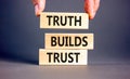Truth builds trust symbol. Concept words Truth builds trust on wooden blocks on a beautiful grey table grey background. Royalty Free Stock Photo