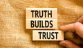 Truth builds trust symbol. Concept words Truth builds trust on wooden blocks on a beautiful canvas table canvas background. Royalty Free Stock Photo