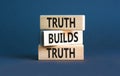Truth builds trust symbol. Concept words Truth builds trust on wooden blocks on a beautiful grey table grey background. Business Royalty Free Stock Photo