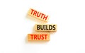 Truth builds trust symbol. Concept words Truth builds trust on wooden blocks on a beautiful white table white background. Business