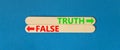 Truth or false symbol. Concept word Truth or False on beautiful wooden stick. Beautiful blue table blue background. Business and