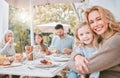 In truth a family is what you make it. a mother hugging her daughter at a family lunch at home. Royalty Free Stock Photo