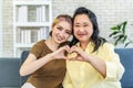 In truth, a family is what you make it. Shot of happy smiling asian senior mother and daughter making a heart sign with their Royalty Free Stock Photo