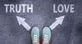 Truth and love as different choices in life - pictured as words Truth, love on a road to symbolize making decision and picking Royalty Free Stock Photo