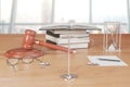 Truth scales with gavel, books and hourglass on wooden table