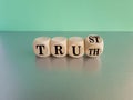 Truth or trust symbol. Turned wooden cubes and changes the word Truth to Trust. Beautiful blue background, grey table. Business Royalty Free Stock Photo