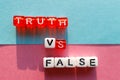 Truth versus lie written in letters on cubes, different color of letters and background