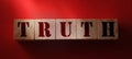 Truth word on wooden cubes on red. True or false facts, real and fake news concept Royalty Free Stock Photo