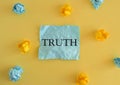 TRUTH word written on colorful paper, Conceptual photo, Colored crumpled reminder paper, yellow background. business concept. Flat Royalty Free Stock Photo