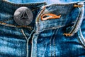 Trx coin instead of buttons on jeans.