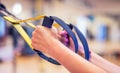 TRX. Female hands with fitness TRX straps in gym Royalty Free Stock Photo